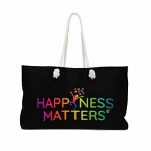 black canvas tote bag with natural white handles and the rainbow colored Happiness Matters logo